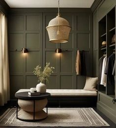 a living room with green walls and wooden paneling, a white rug on the floor and a black coffee table in front of it