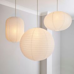 three white paper lanterns hanging from the ceiling