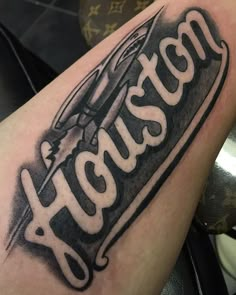 a black and white photo of a tattoo with the word houston written in cursive font