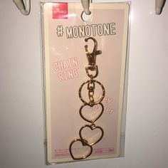 there is a keychain that has hearts on it and the words chain ring are hanging from hooks