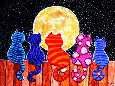 three cats sitting on a fence looking at the moon