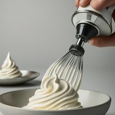 a whisk being used to whip whipped cream