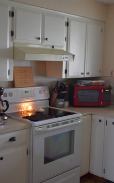 a kitchen with white cabinets and an oven