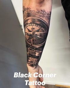 a man's arm with a compass tattoo on it