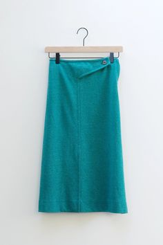 You won't find a piece like this! A decorative cross front button waist gives this casual piece an artsy flair and elastic waistband makes a comfortable fit. Front vent provides easier movement. Side hidden zip closure. Fabric is super comfortable and a heather teal green color. Slimming a-line silhouette. Wear this with sneakers or slides and a cropped t-shirt. Measurements: Waist 25", Length 27" Brand: Graff Californiawear Tag Size: N/A Fabric: N/A Decorative Cross, Asymmetrical Midi Skirt, Teal Green Color, Crosses Decor, Sports Skirts, Teal Green, New Wave, Midi Skirt, Comfort Fit