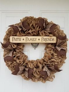 a wreath with the words faith family friends hanging on it's front door,