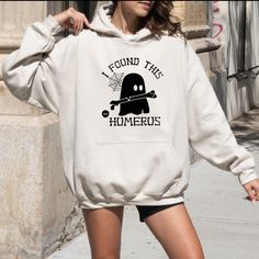 I Found This Humerus Hoodie, Funny Ghost Hoodie, Halloween Spooky Hoodie, Funny Halloween Hoodie, Humerus Hoodie, Halloween Gift Hoodie 💖Youth Hoodies do not have drawcord for added safety!💖 Material: 50% cotton, 50% polyester for a comfortable and durable blend. Fabric: Medium-heavy (8.0 oz/yd² or 271.25 g/m²) for warmth on cooler days. Fit: Loose fit for comfort without sacrificing style. Label: Sewn-in for a seamless feel. Sizing: Check our sizing chart for the right fit. HOW TO PLACE YOUR Casual Halloween Cosplay Hoodie, Halloween Cosplay Long Sleeve Sweatshirt, Halloween Cosplay Hoodie, Halloween Cosplay Hoodie With Drawstring Hood, Halloween Cosplay Hoodie With Crew Neck, Halloween Cosplay Crew Neck Hoodie, Halloween Hooded Hoodie With Letter Print, Hooded Hoodie With Drawstring For Halloween, Halloween Hoodie With Drawstring Hood