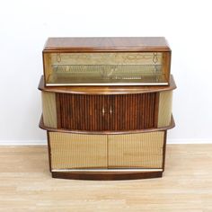 an old fashioned wooden cabinet with glass doors