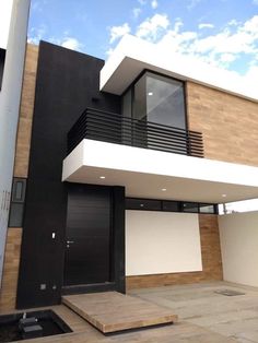 a black and white house with stairs leading up to it