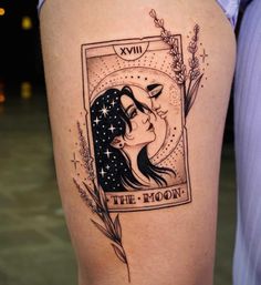 a woman's thigh with an image of the moon and stars on it