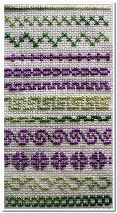 a close up of a cross stitch pattern with purple and green flowers on the side