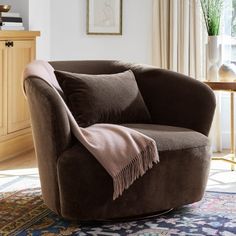 a living room with a brown chair and rug