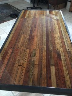 a table that has been made out of wooden planks and measuring tape on it