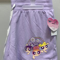 a purple shorts with cartoon characters on it and a tag attached to the bottom part