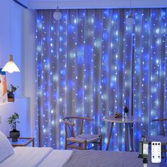 a bed room with a neatly made bed and blue lights on the wall behind it