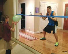 a man and boy are playing with a balloon