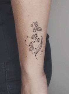 a woman's arm with a flower tattoo on the left side of her body