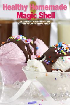 two scoops of ice cream with sprinkles in a glass bowl on a table