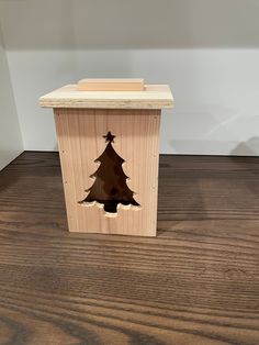 a wooden box with a cut out of a christmas tree