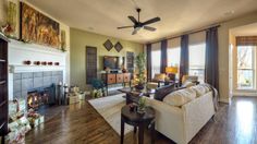 a living room filled with furniture and a fire place in the middle of a room