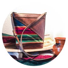 This crossbody bag is a beautifully hand crafted piece made in Bolivia. It's perfect for any adventure, day or night. Purse contains one compartment, as well as an inside zipper pocket, and closes with a zipper at the top. Strap is adjustable. The whole piece is made with authentic leather, with stamped details, and features a beautiful woven pattern on the front. Approximate Measurements:  10 inches tall x 10 inches wide x 4 inches deep at base Strap drop length is approximately 25 inches at longest. (Can be adjusted to shorten.) Artisan Travel Shoulder Bag With Leather Lining, Artisan Shoulder Bag With Leather Lining For Travel, Artisan Shoulder Bag For Travel With Leather Lining, Artisan Crossbody Satchel With Leather Lining, Artisan Crossbody Shoulder Bag With Leather Lining, Artisan Shoulder Bag For Everyday Use, Large Purse, Woven Pattern, Leather Weaving