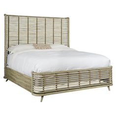 the bed is made up with white linens and wood slats on it's headboard