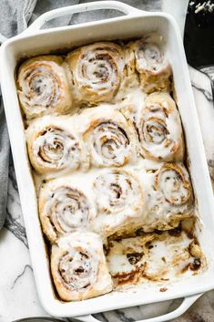 a pan filled with cinnamon rolls on top of a table