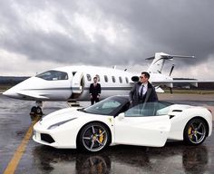 a man standing next to a white sports car in front of a private jet airplane