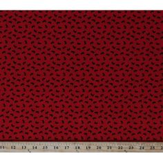 red and black leopard print fabric with a ruler in front of the image, it is very