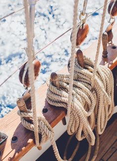 ropes on the side of a boat with water in the background