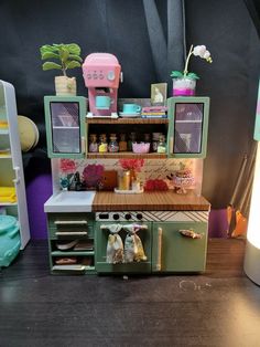 an old fashioned toy stove and oven in a play kitchen