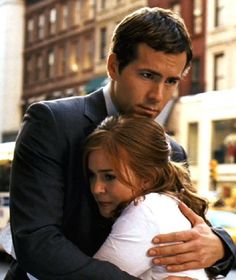 a man in a suit hugging a woman on the street