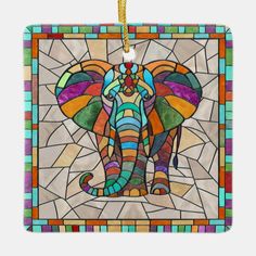 an elephant is depicted in this colorful stained glass ornament