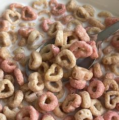 a bowl full of cereal with a spoon in it