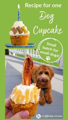 a person holding up a cupcake with bacon on it and a dog sitting next to it