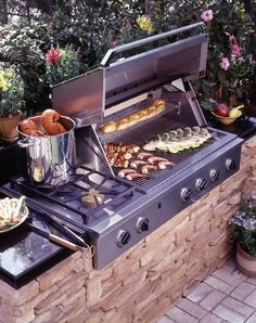 an outdoor bbq grill with food cooking on it