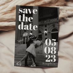 a save the date card on top of a furnishing blanket with an image of two people kissing