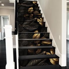 the stairs are decorated with black and gold leaves