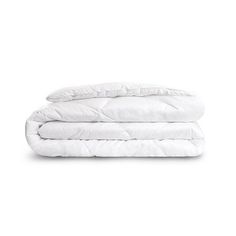 the white comforter is folded on top of two pillows