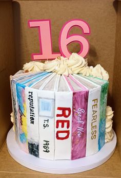 a cake made to look like a book with the number six on it and decorated with books