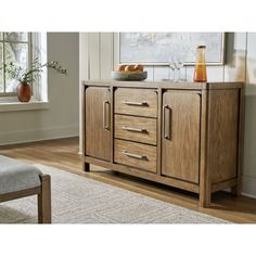 a wooden cabinet with drawers and doors in a living room