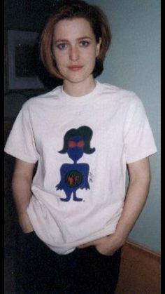 a woman wearing a t - shirt with an image of a person on it