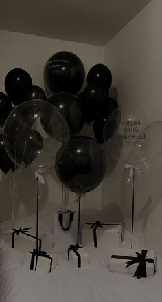 black and white balloons are on the bed