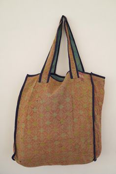 This bag is made from a vintage hand-stitched Kantha quilt. We make only 1-2 bags from each quilt and every one of them is one of a kind! Details: Shell fabric- Vintage Quilted Cotton Kantha 1. width (cm) - 40 2. height (cm)- 45 3. depth (cm) - 45 4. weight (g)- 0.400 kg 5. length of the shoulder (cm) -40 cm Care instructions: Dry clean or Hand-wash in warm water. Drip dry. How it's made: Kantha quilts are made using numerous layers of recycled silk or cotton saris which are hand-stitched in the Green Quilted Square Bag, Square Green Quilted Bag, Green Quilted Rectangular Bag, Brown Quilted Rectangular Bag, Hand-stitched Tote Shoulder Bag For Daily Use, Daily Use Hand-stitched Tote Shoulder Bag, Daily Use Tote Shoulder Bag, Hand-stitched, Vintage Green Square Bag, Vintage Square Green Bag