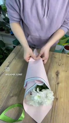 a person cutting up food on top of a wooden table