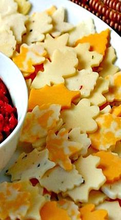 crackers with cheese and cranberry sauce in a bowl on a white plate