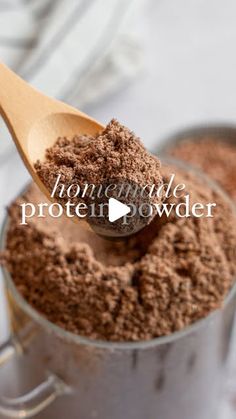 a wooden spoon filled with chocolate protein powder