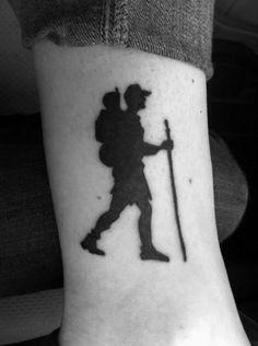 a black and white photo of a person with a baseball bat on their foot,