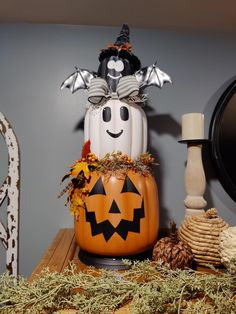 a decorated pumpkin sitting on top of a wooden table