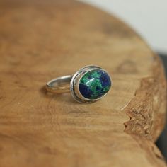 This is the perfect East-West Oval Ring and this Azurite Malachite is so gorgeous, revealing the classic blue of Lapis Lazuli and green of Malachite. The 10X14mm stone rests perfectly in this east west oval configuration. Simple and perfect with just an edge of .925 Sterling Silver. Wear this Azurite Malachite Statement Ring alone or on a hand full of rings. All traditional Silversmithing is done in my Baltimore MD studio. Azurite Malachite 10X14mm Ring top 14X18mm .925 Sterling Silver All tradi Hand Full Of Rings, Silversmith Rings, Malachite Ring, Malachite Rings, Purple Amethyst Ring, Purple Rings, Jasper Ring, Lapis Ring, Lapis Lazuli Ring